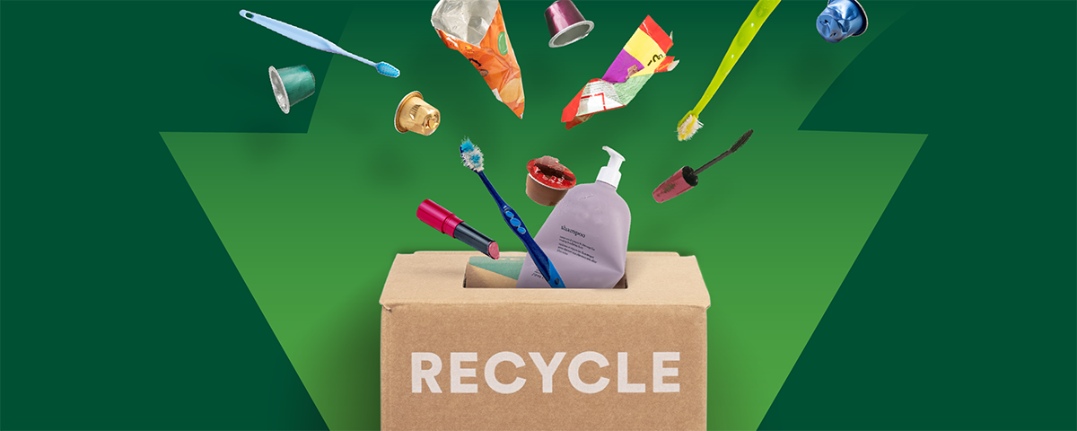 Various recyclable waste displayed on a green background