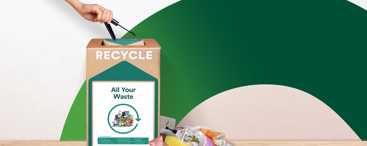 Cardboard box of recycle waste on a green background