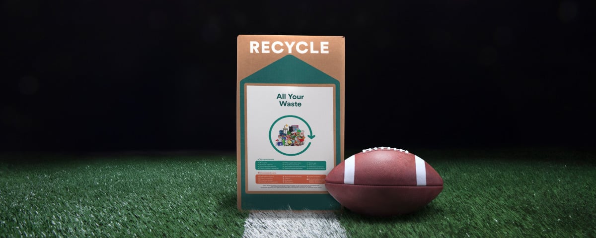 Soccer ball and AIO box displayed on the green grass background